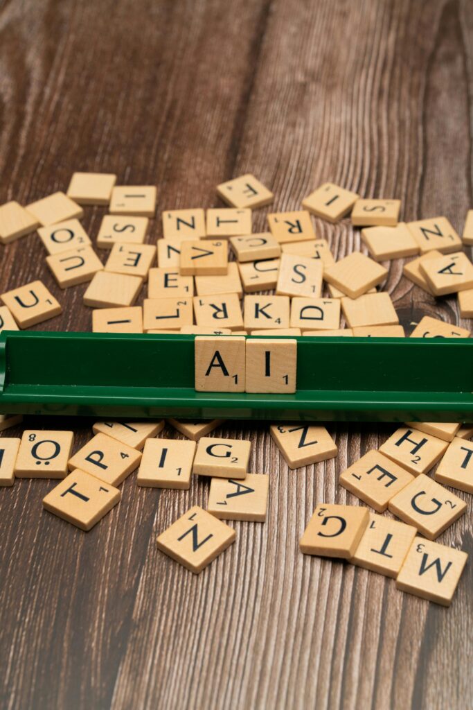 pexels-photo-18524070-18524070 Scrabble tiles spelling 'AI' on a wooden surface symbolize artificial intelligence technology.